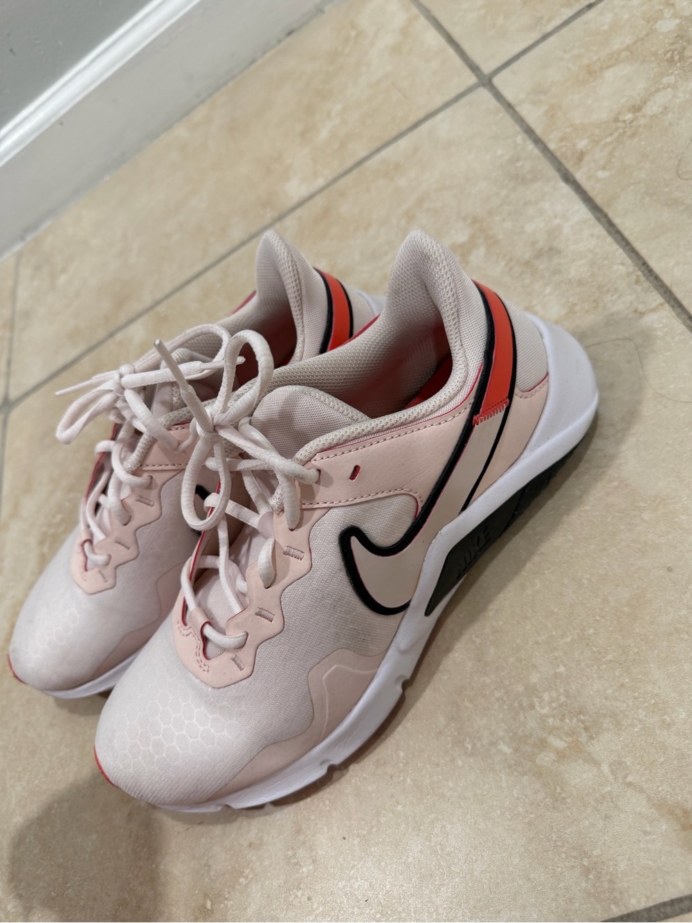 Nike Women's Pale Pink Sneakers with Black Swoosh and Coral Accents